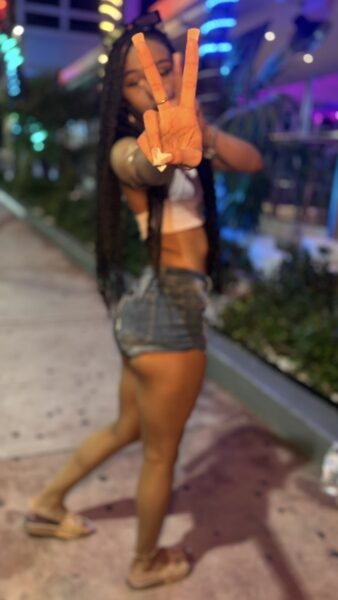 Spearmint Rhino Pittsburgh entertainer showcasing a peace sign, featured on the club’s Roll Call page